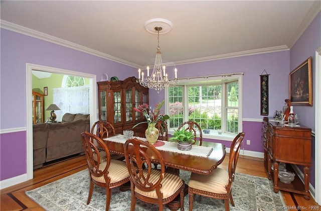 109 Davis Rd, Seymour, CT 06483 - dining space featuring a chandelier, wood finished floors, and ornamental molding