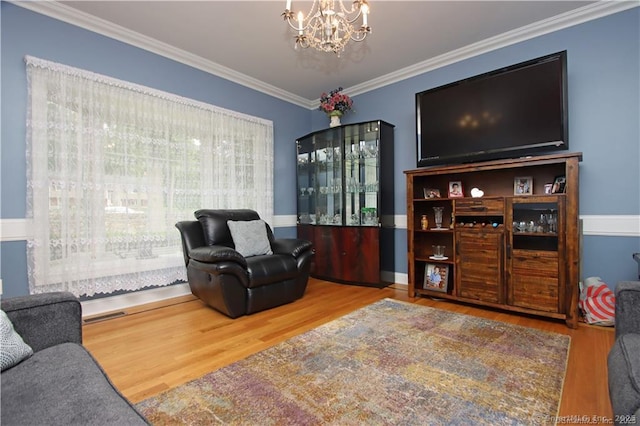 109 Davis Rd, Seymour, CT 06483 - living area featuring wood finished floors, a chandelier, and crown molding