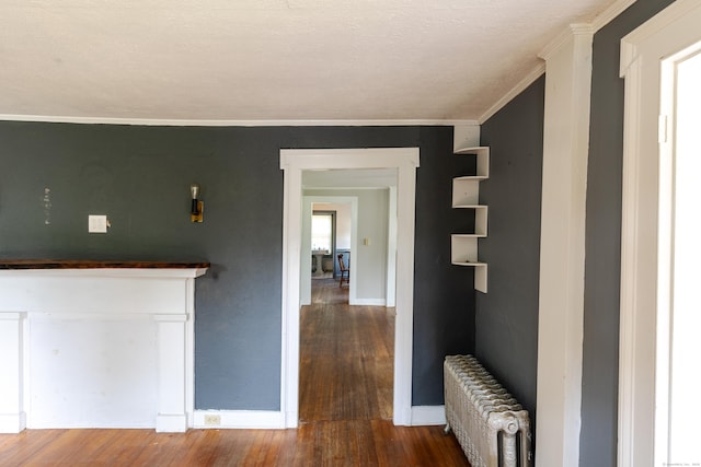114 Spring St, Cheshire, CT 06410 - hall featuring radiator heating unit, wood finished floors, and crown molding