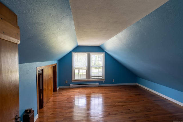 114 Spring St, Cheshire, CT 06410 - additional living space featuring baseboard heating, wood finished floors, a textured ceiling, and vaulted ceiling