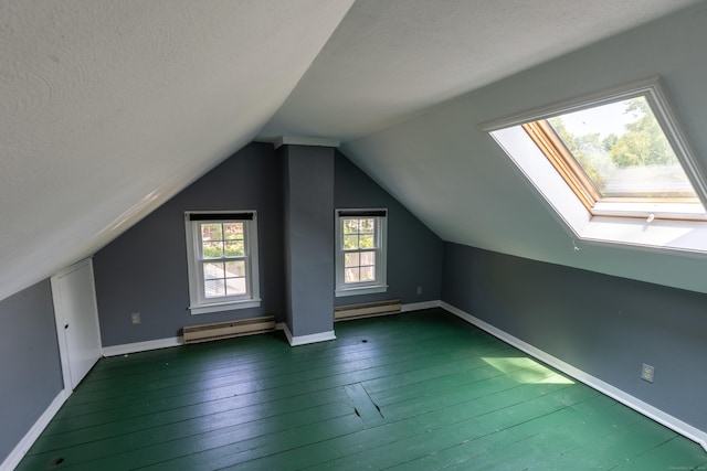 114 Spring St, Cheshire, CT 06410 - additional living space featuring a baseboard heating unit, wood-type flooring, lofted ceiling, and a textured ceiling