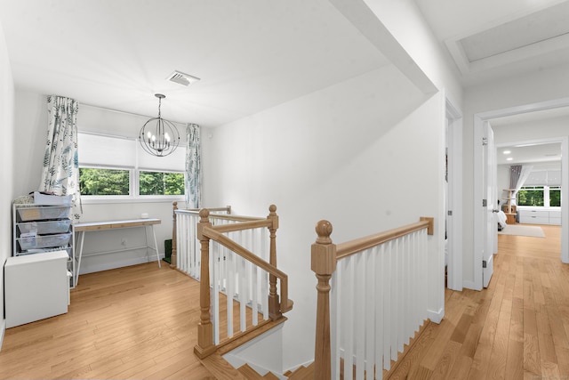 2 Sabrinas Ct, Norwich, CT 06360 - hall featuring an upstairs landing, light wood-style floors, and a chandelier