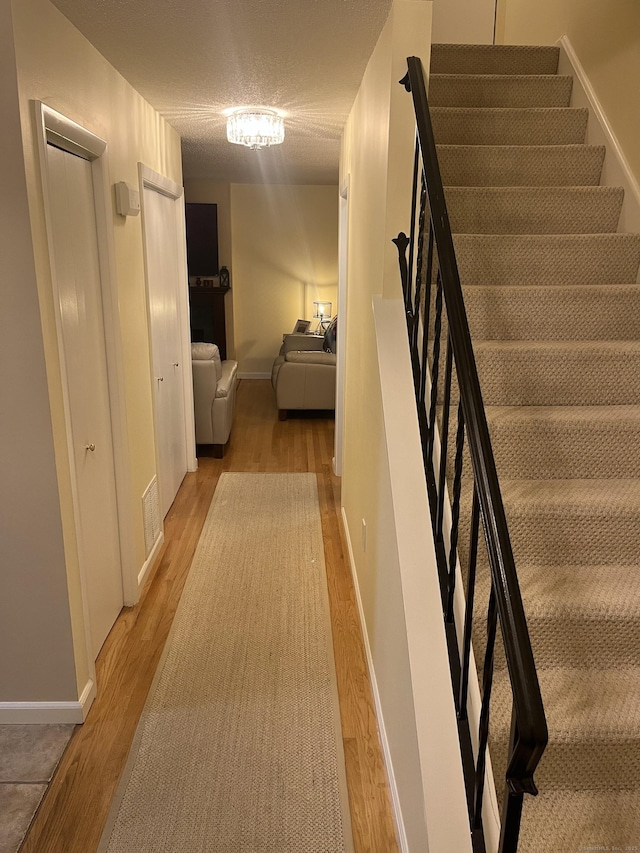 560 Yale Ave Unit 124, Meriden, CT 06450 - stairs featuring wood finished floors and a textured ceiling