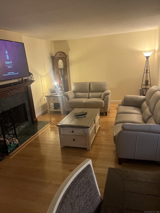 560 Yale Ave Unit 124, Meriden, CT 06450 - living area with light wood finished floors, a premium fireplace, and a textured ceiling