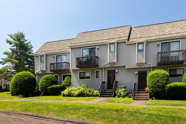 560 Yale Ave Unit 124, Meriden, CT 06450 - view of front of home featuring a balcony, a front yard, and roof with shingles