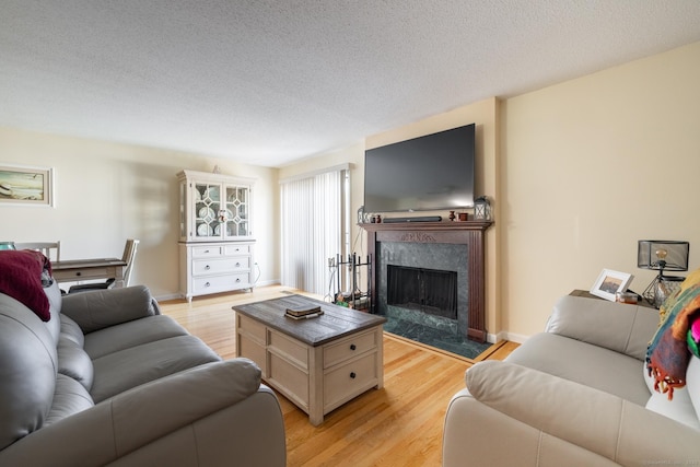 560 Yale Ave Unit 124, Meriden, CT 06450 - living room featuring light wood-style flooring, a premium fireplace, and a textured ceiling