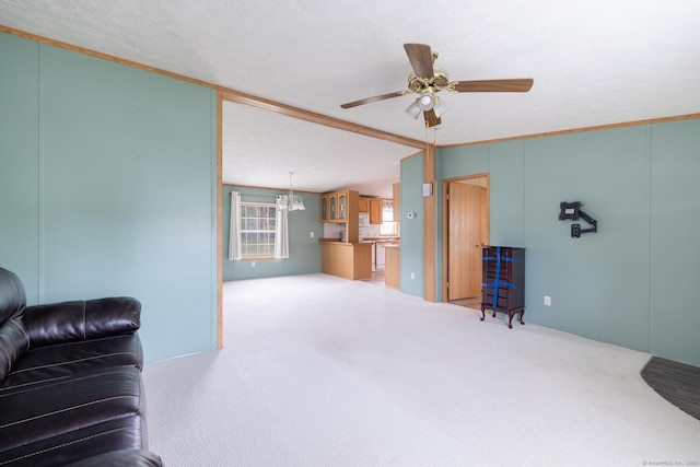 8 Haley Ln, Windham, CT 06256 - carpeted living room with a ceiling fan, a chandelier, and crown molding