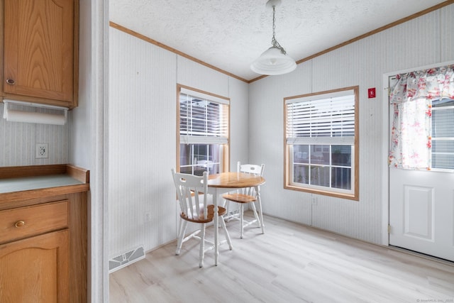 8 Haley Ln, Windham, CT 06256 - dining room with crown molding, light wood-style flooring, and a textured ceiling