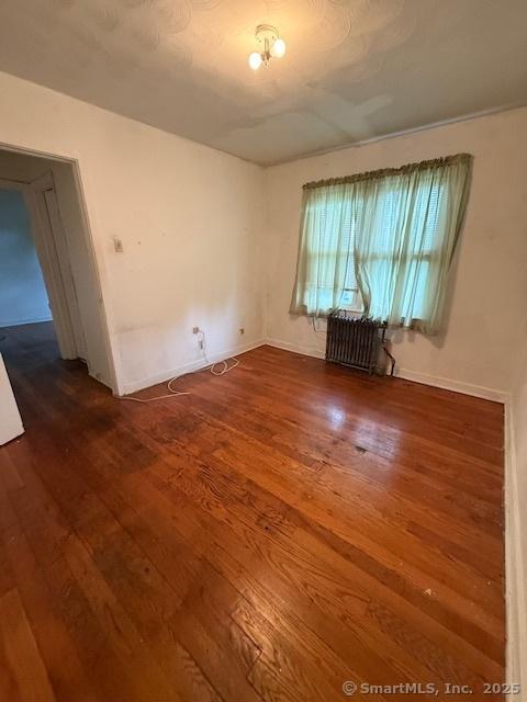 347 Weber St Unit 21Building 97, Stratford, CT 06614 - empty room featuring radiator heating unit and wood finished floors