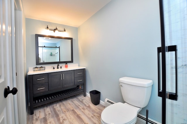 503 Mulberry St, Southington, CT 06479 - bathroom with vanity, a baseboard heating unit, wood finished floors, and an enclosed shower