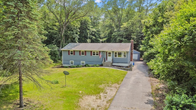 837 Long Cove Rd, Ledyard, CT 06335 - view of front facade featuring an outdoor structure, a chimney, a front yard, a garage, and a view of trees