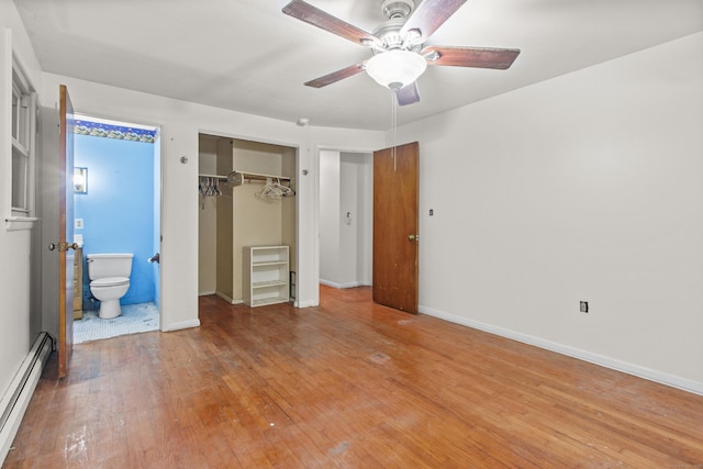 837 Long Cove Rd, Ledyard, CT 06335 - unfurnished bedroom with a baseboard radiator, light wood-type flooring, a closet, ensuite bathroom, and a ceiling fan