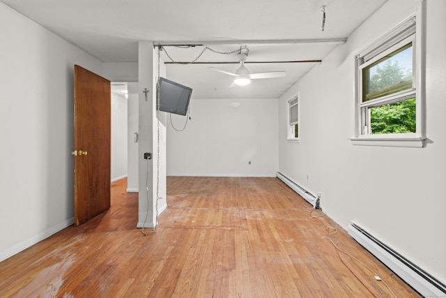 837 Long Cove Rd, Ledyard, CT 06335 - below grade area with a baseboard radiator, a ceiling fan, and light wood finished floors