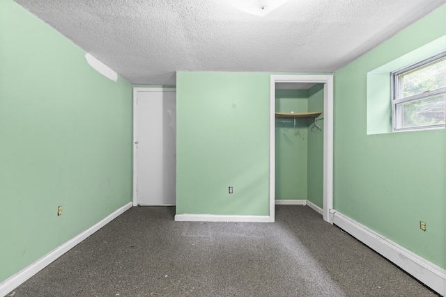 837 Long Cove Rd, Ledyard, CT 06335 - unfurnished bedroom with a textured ceiling, baseboard heating, and carpet