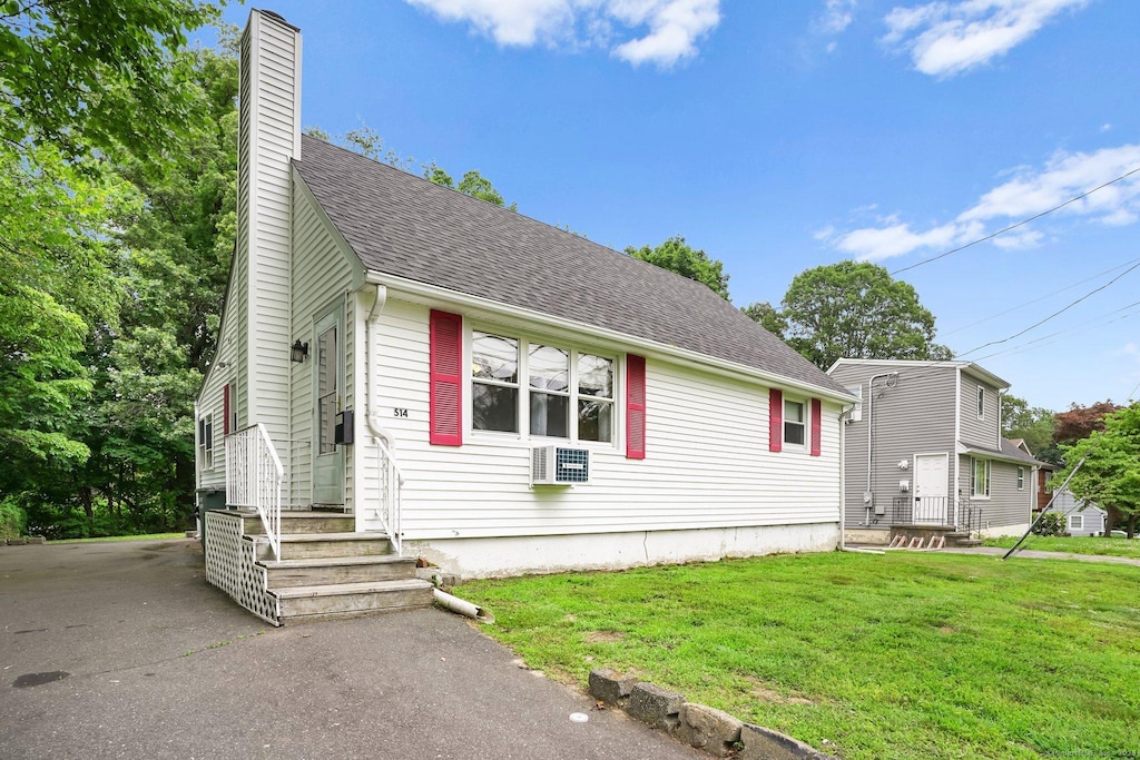 514 Peet St, Bridgeport, CT 06606 - view of front of home with a chimney, a front lawn, and a shingled roof