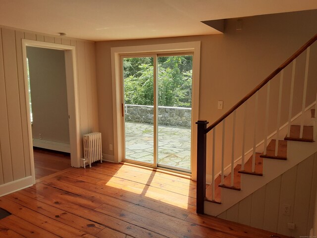 67 Hanover Rd, Newtown, CT 06470 - doorway to outside featuring radiator heating unit, hardwood / wood-style floors, stairway, and baseboard heating