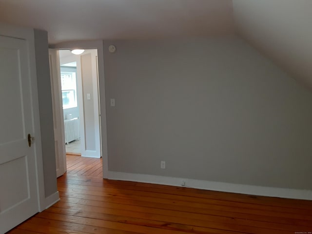 67 Hanover Rd, Newtown, CT 06470 - bonus room featuring radiator, wood-type flooring, and vaulted ceiling