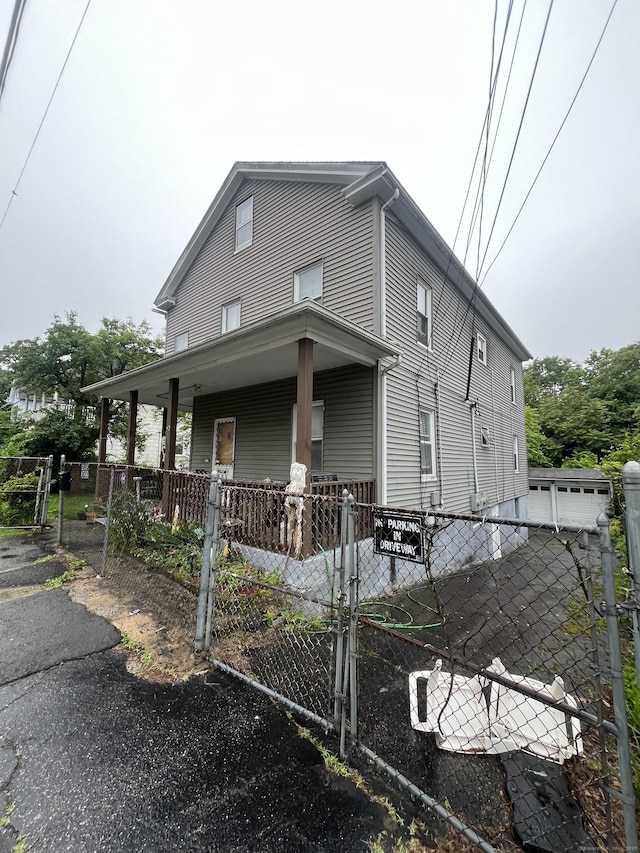 52 Beech St, Waterbury, CT 06704 - view of front of home with covered porch, a gate, and a fenced front yard