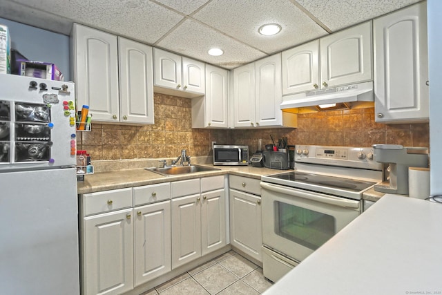 330 Short Beach Rd Apt G13, East Haven, CT 06512 - kitchen with white appliances, under cabinet range hood, light tile patterned flooring, white cabinets, and recessed lighting