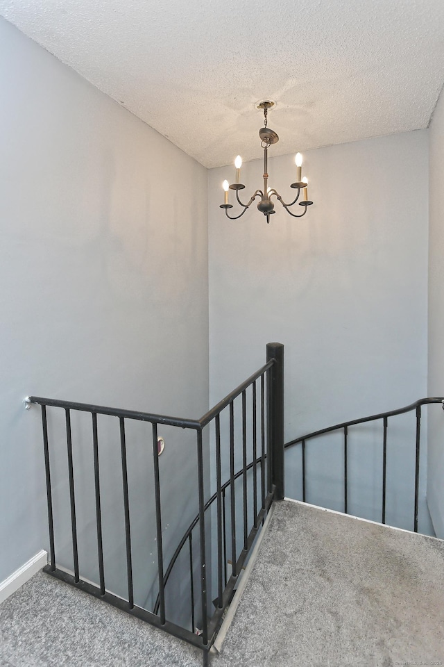 330 Short Beach Rd Apt G13, East Haven, CT 06512 - stairs featuring carpet, a chandelier, and a textured ceiling