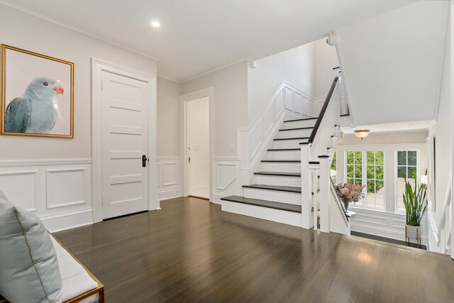 336 Ocean Dr W, Stamford, CT 06902 - unfurnished living room with a decorative wall, dark wood-type flooring, stairs, ornamental molding, and a wainscoted wall