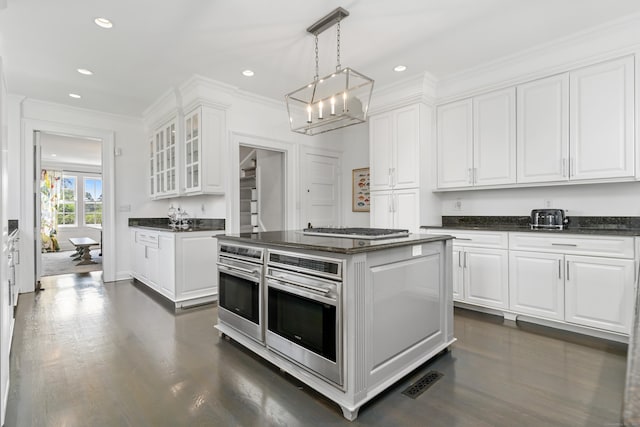 336 Ocean Dr W, Stamford, CT 06902 - kitchen with white cabinets, glass insert cabinets, crown molding, appliances with stainless steel finishes, and recessed lighting