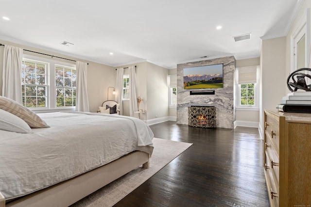 336 Ocean Dr W, Stamford, CT 06902 - bedroom with crown molding, a fireplace, dark wood-type flooring, and recessed lighting