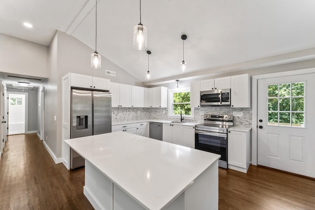 33 Williams Rd, Monroe, CT 06468 - kitchen with appliances with stainless steel finishes, decorative backsplash, dark wood-style flooring, light countertops, and high vaulted ceiling