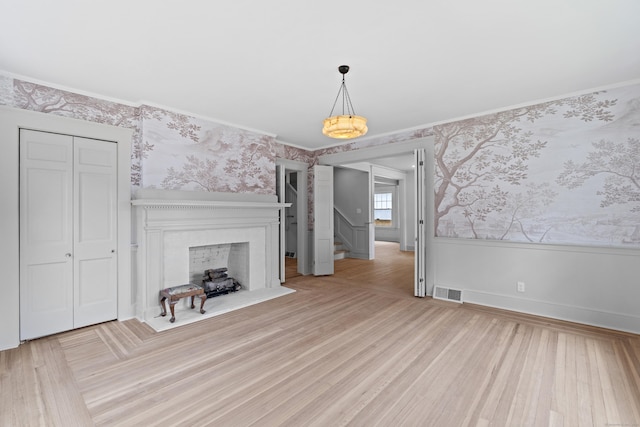 119 Westwood Rd, New Haven, CT 06515 - unfurnished living room featuring wallpapered walls, ornamental molding, stairs, wood finished floors, and a fireplace