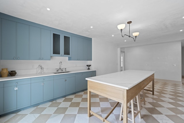 119 Westwood Rd, New Haven, CT 06515 - kitchen featuring light floors, recessed lighting, blue cabinets, light countertops, and a chandelier