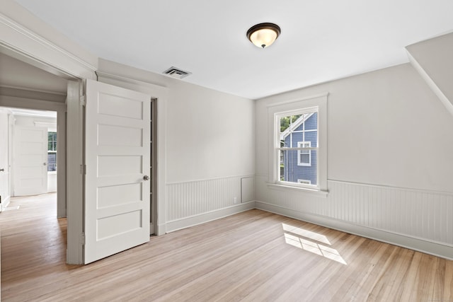 119 Westwood Rd, New Haven, CT 06515 - unfurnished room featuring light wood finished floors and a wainscoted wall