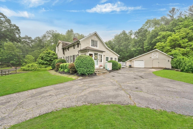 268 Hattertown Rd, Monroe, CT 06468 - view of front facade with an outbuilding, a chimney, a detached garage, a front yard, and asphalt driveway