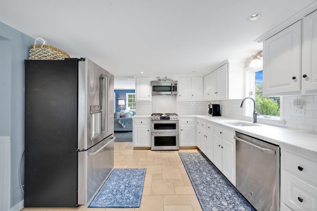 268 Hattertown Rd, Monroe, CT 06468 - kitchen featuring stainless steel appliances, decorative backsplash, white cabinetry, and recessed lighting