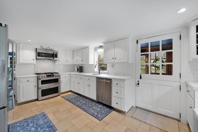 268 Hattertown Rd, Monroe, CT 06468 - kitchen featuring appliances with stainless steel finishes, decorative backsplash, light countertops, and recessed lighting