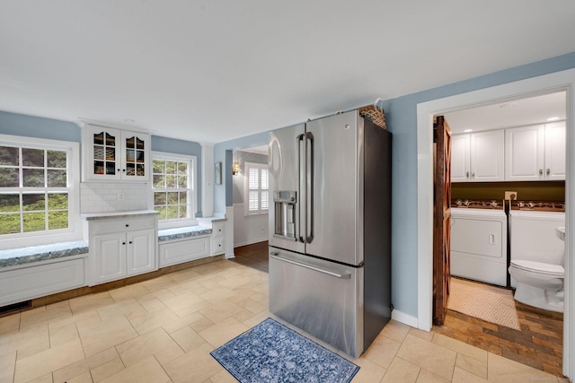 268 Hattertown Rd, Monroe, CT 06468 - kitchen with stainless steel refrigerator with ice dispenser, washer and dryer, white cabinetry, and glass insert cabinets