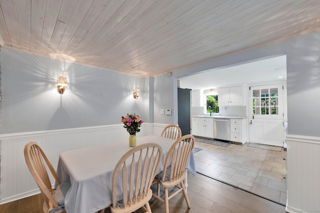 268 Hattertown Rd, Monroe, CT 06468 - dining space with wainscoting, light wood-style floors, and wooden ceiling