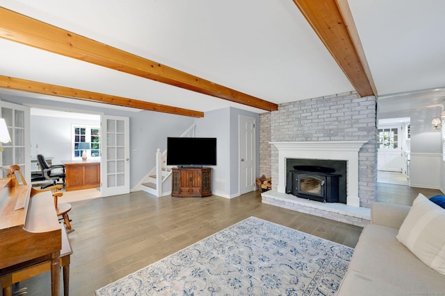 268 Hattertown Rd, Monroe, CT 06468 - living room with healthy amount of natural light, beam ceiling, wood finished floors, and stairway