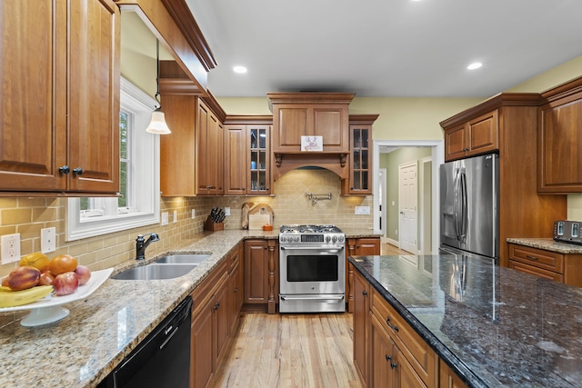 28 Hoop Pole Hill Rd, Chester, CT 06412 - kitchen with stainless steel appliances, brown cabinets, light wood finished floors, stone countertops, and glass insert cabinets