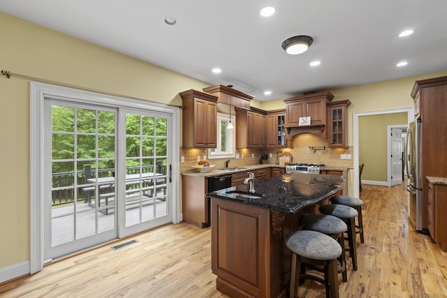 28 Hoop Pole Hill Rd, Chester, CT 06412 - kitchen with freestanding refrigerator, decorative backsplash, dark stone countertops, light wood finished floors, and a center island with sink