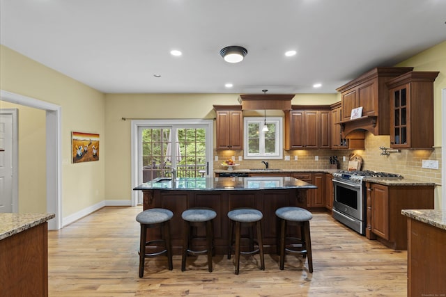 28 Hoop Pole Hill Rd, Chester, CT 06412 - kitchen featuring stainless steel gas range, a kitchen bar, light wood-style flooring, backsplash, and recessed lighting