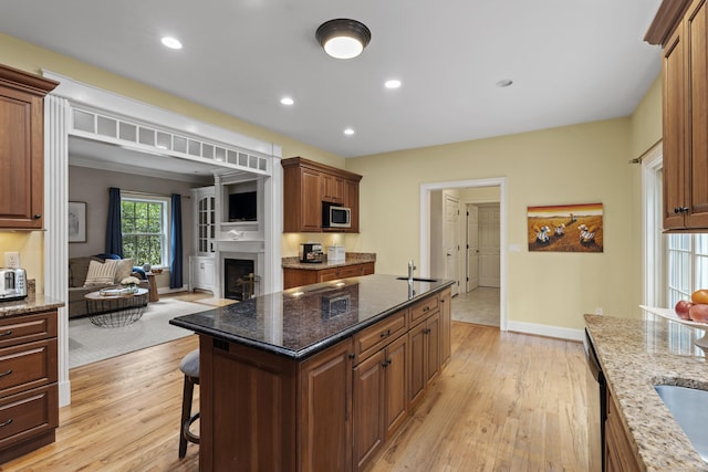 28 Hoop Pole Hill Rd, Chester, CT 06412 - kitchen featuring stainless steel microwave, open floor plan, light wood-style flooring, a kitchen breakfast bar, and recessed lighting