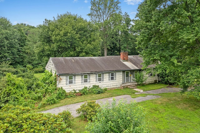 15 Pocconock Trl, New Canaan, CT 06840 - view of front of house featuring a chimney and a front lawn