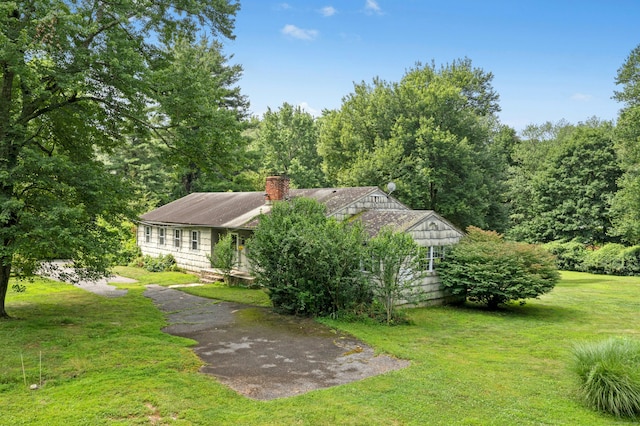 15 Pocconock Trl, New Canaan, CT 06840 - view of front of house featuring a front lawn and a chimney