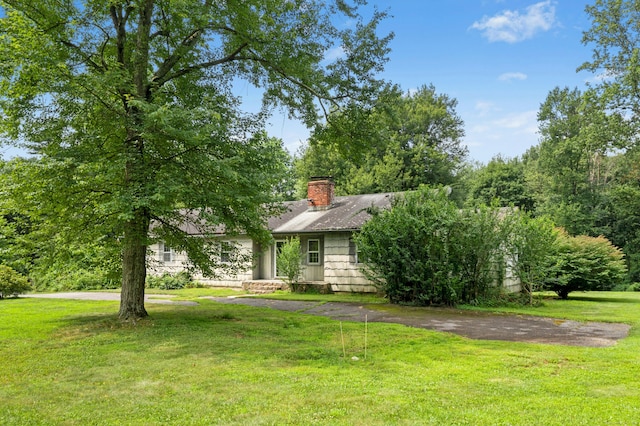 15 Pocconock Trl, New Canaan, CT 06840 - view of property hidden behind natural elements featuring a front lawn and a chimney