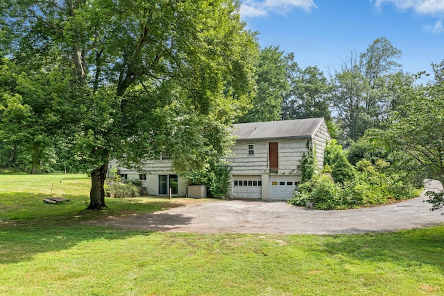 15 Pocconock Trl, New Canaan, CT 06840 - view of front of home featuring driveway, a garage, and a front lawn