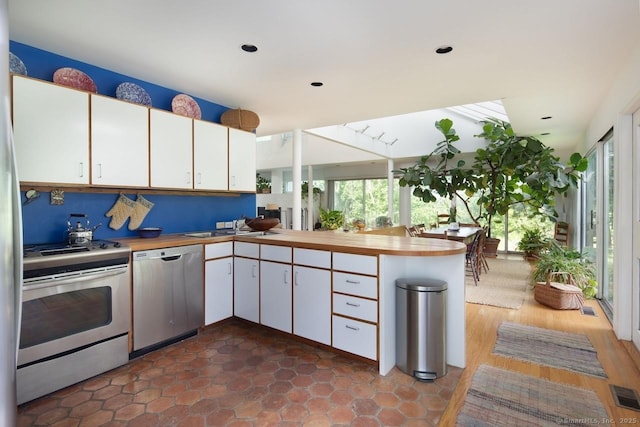 52 Cooper Hill Rd, Salisbury, CT 06068 - kitchen with stainless steel appliances, plenty of natural light, and white cabinetry