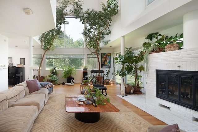 52 Cooper Hill Rd, Salisbury, CT 06068 - living room featuring a fireplace, wood finished floors, and a towering ceiling