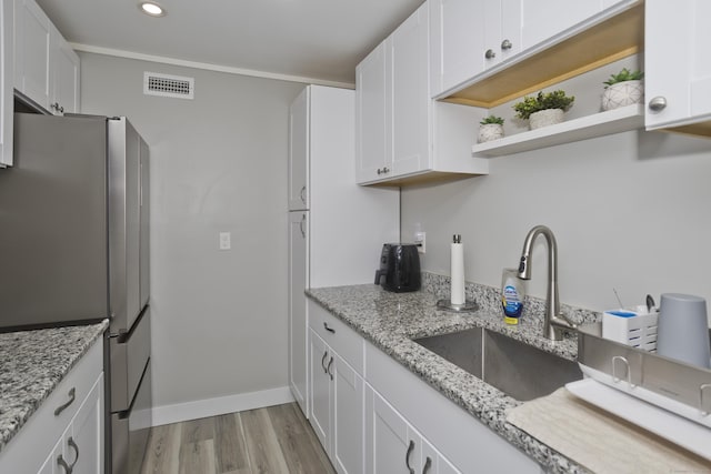 73 Landing Cir Unit 73, Suffield, CT 06078 - kitchen with freestanding refrigerator, light wood finished floors, white cabinets, recessed lighting, and open shelves