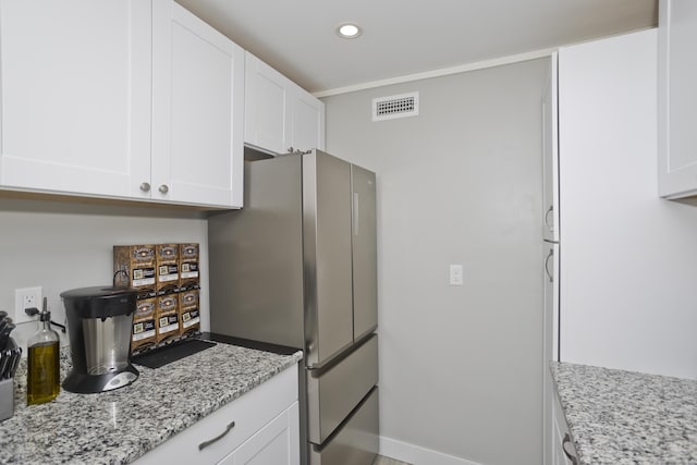 73 Landing Cir Unit 73, Suffield, CT 06078 - kitchen featuring freestanding refrigerator, white cabinets, recessed lighting, and light stone counters
