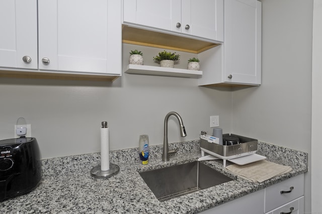 73 Landing Cir Unit 73, Suffield, CT 06078 - kitchen with white cabinets, light stone counters, and open shelves